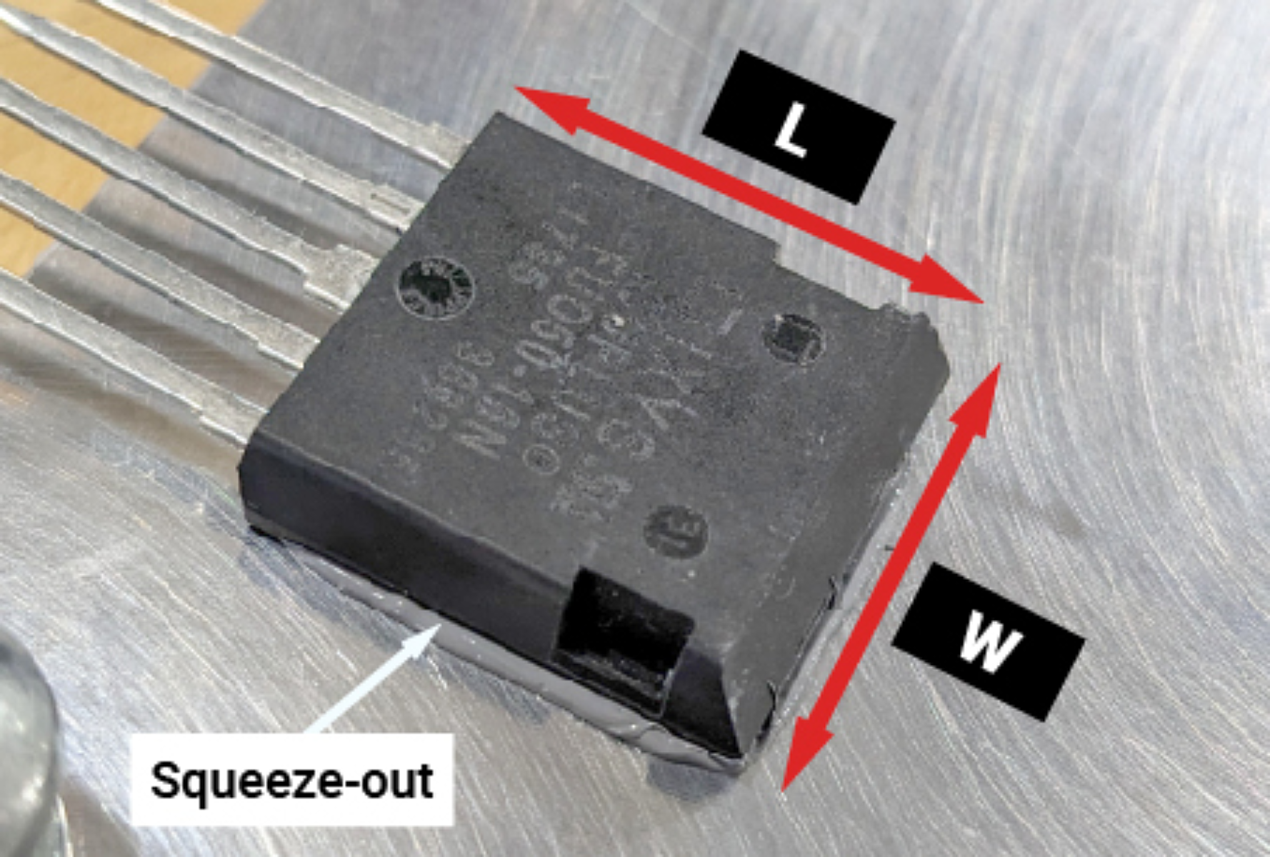 Fig 8. Excess thermal paste is evident along all four sides of the device. The TIM amount can be calculated from the semiconductor dimensions.
